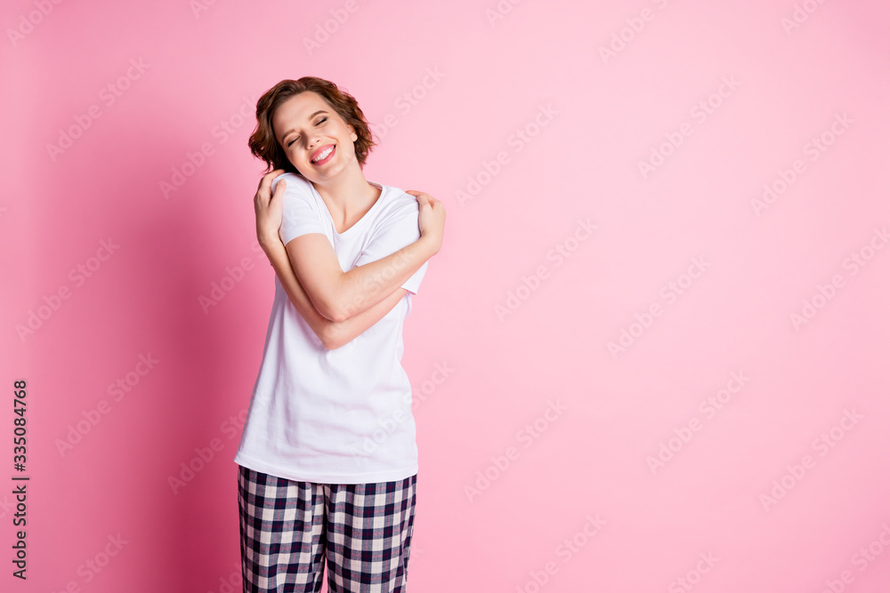 Photo of nice lady enjoy saturday morning hold hug shoulders hands warm  comfort bed sleepy weekend eyes closed wear white t-shirt plaid pajama pants  isolated pink color background Stock Photo | Adobe
