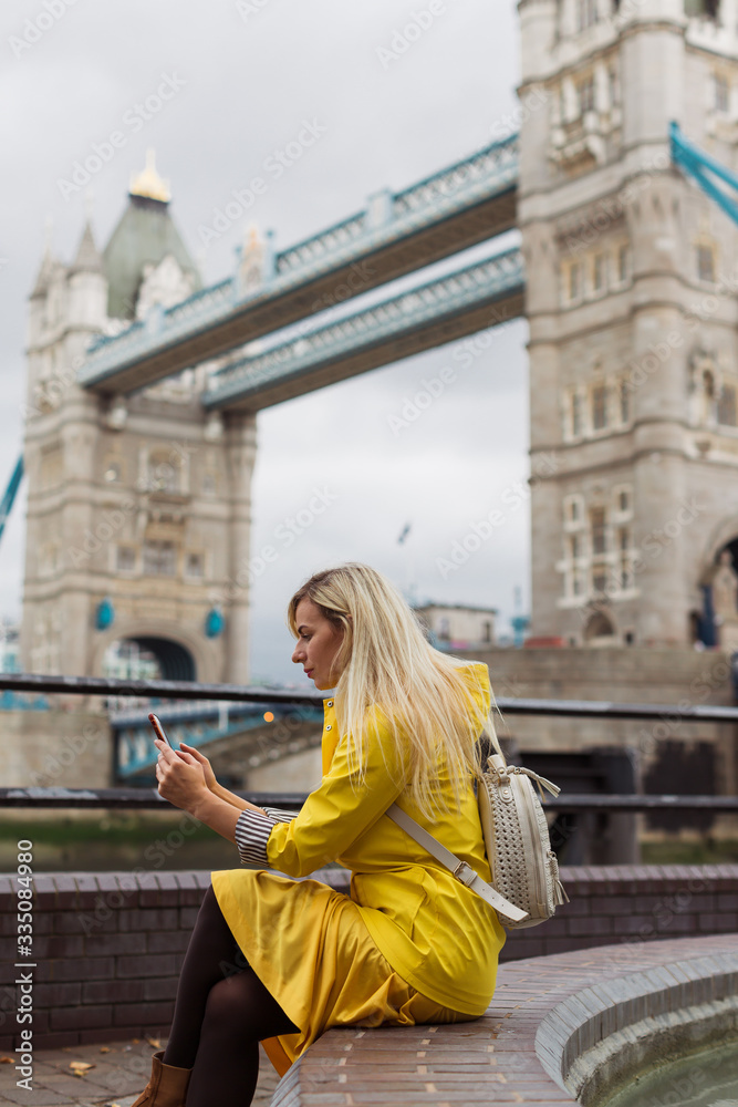 girl charting on the phone at the london bridge