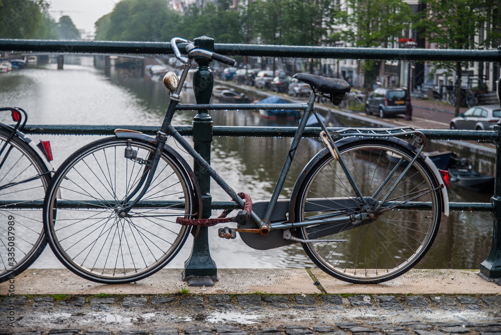 bicycle chained to bridge in Amsterdam