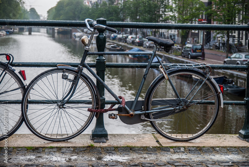 bicycle chained to bridge in Amsterdam