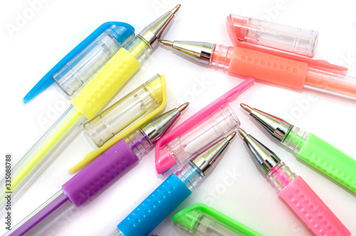 multi-colored pens on a white background. Close-up.