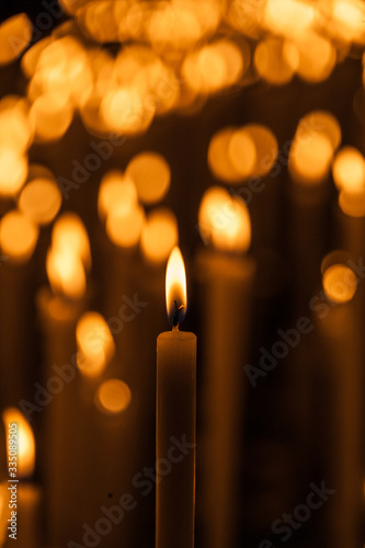 Lit candle with out of focus background