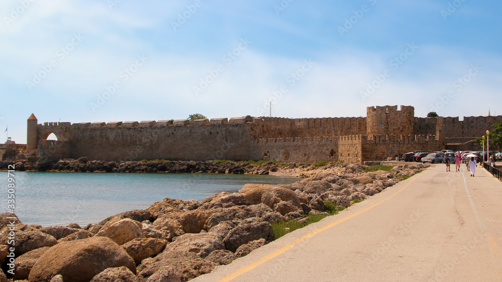 View of the embankment and the medieval fortress, Mandraki Harbour, Rhodes, Greece