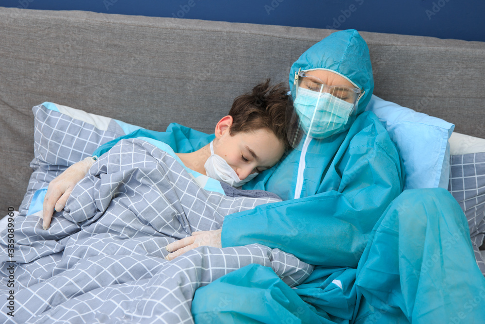 Infected boy patient in quarantine lying in bed, coronavirus concept , Mother and child in home quarantine , quarantine. health concept. Corona Virus. Infected boy patient in quarantine lying in bed, coronavirus concept , Mother and child in home quarantine , quarantine. health concept. Corona Virus.