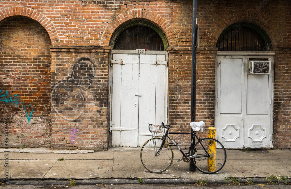 old bicycle in front of a brick wall