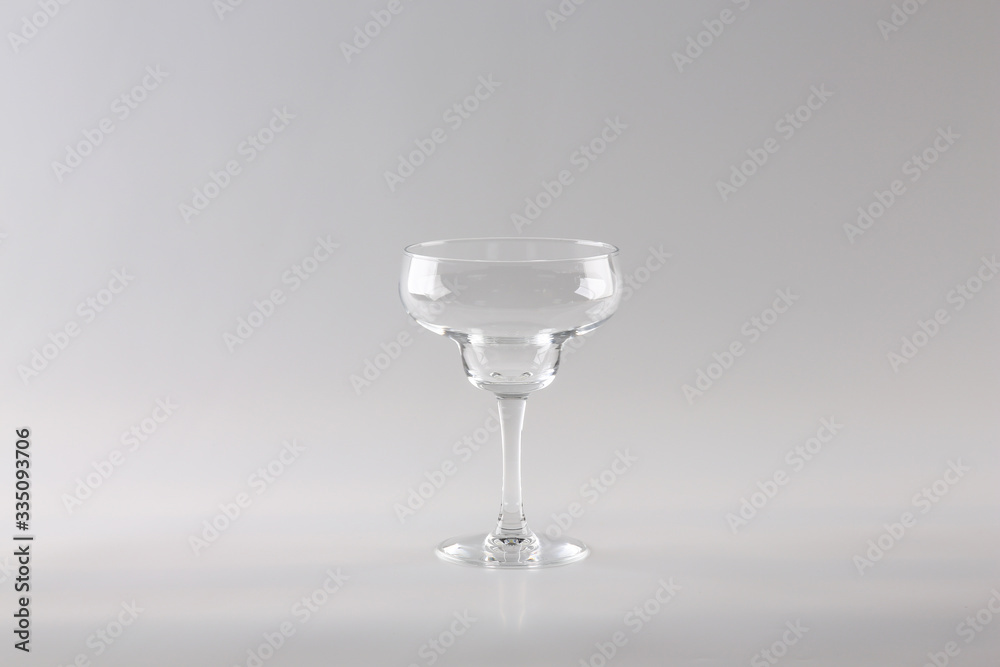 transparent Margarita glass on a light background in the Studio. transparent Margarita glass on a light background in the Studio.