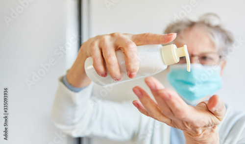 Disinfect female doctor with mouth protection while hands