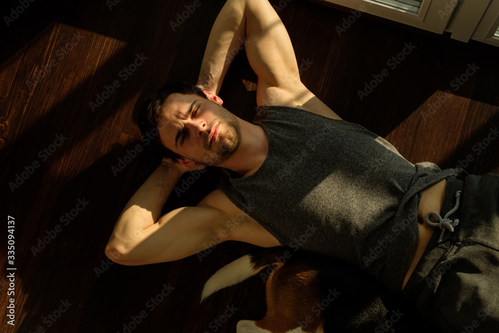 Handsome man doing abdominal exercises at home