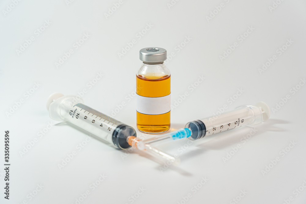 Orange vaccine bottle with blank label and syringe injection on white background Orange vaccine bottle with blank label and syringe injection on white background