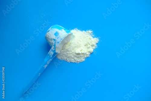 Milk powder for baby in measuring spoon.