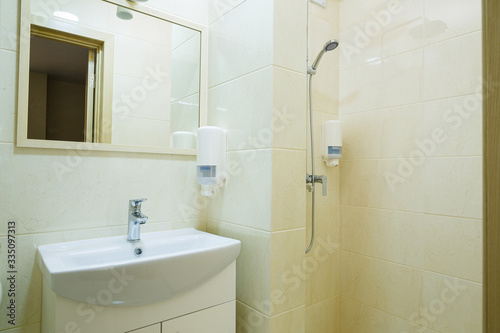 Bright bathroom  white toilet  washbasin  mirror  shower