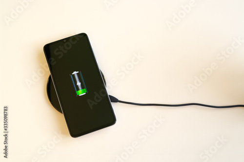 Smartphone wireless charging on induction charger. Wireless charger. Copy space