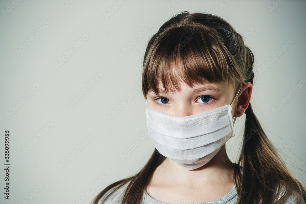 girl in a medical mask on a white background girl in a medical mask on a white background