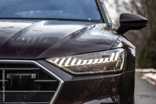 Laser and matrix headlights of a premium car. Close-up.