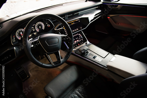 Interior of an ultra modern new luxury car. Leather chairs and wood trim, touch panels with vibration feedback and climate control. Multifunction, automatic transmission © Dmitry Dven