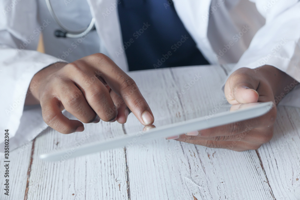 Close up of doctor hand use digital tablet.