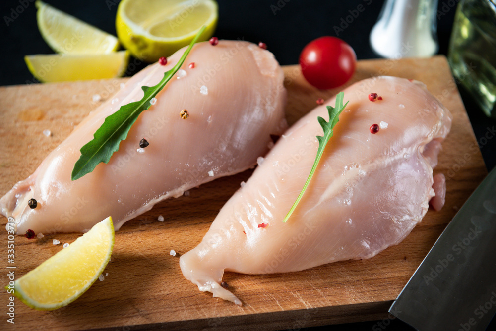 chicken fillet on the kitchen Board, tomatoes , lemon, herbs, meat chicken fillet on the kitchen Board, tomatoes , lemon, herbs, meat
