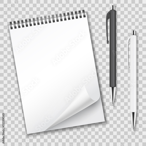 Vertical clean blank spiral notebook with curled sheet and ballpoint pens automatic.