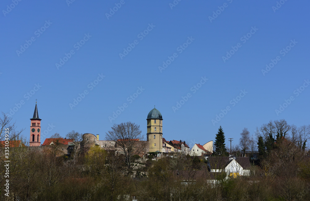 03/28/2020, detailed view of the city of Friedberg in Bavaria with parts of the historic city wall and towers against a blue sky in spring