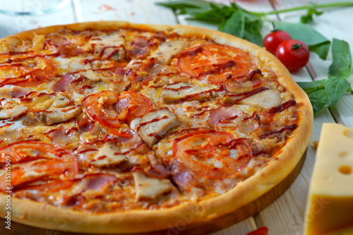 pizza with sausage, mushrooms and tomatoes