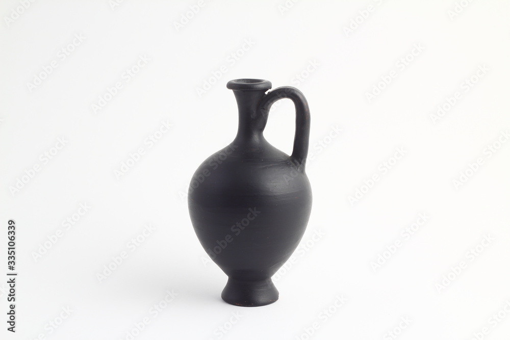 clay black jug isolated on a white background. vintage empty jug front view. vintage capacity