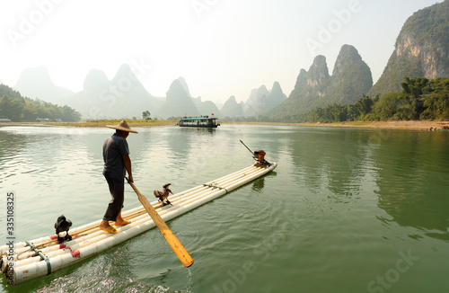 Silhouette of Fishing Men and His Cormorants on Li River at Sunrise  Guilin  China. The Li River or Lijiang is a river in Guangxi Zhuang Autonomous Region  China.