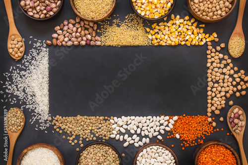 Different type of raw dry legumes composition. White beans, lentils, bulgur, chickpeas, kidney beans, corns, rice,  Mix organic legume concept, copy space photo