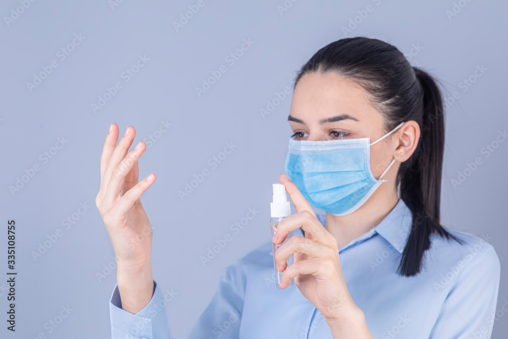 Girl with protective mask holdding alcohol spray cleaning protect disease covid 19 Girl with protective mask holdding alcohol spray cleaning protect disease covid 19