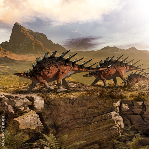 Kentrosaurus dinosaurs marching in prehistoric landscape © ratpack223