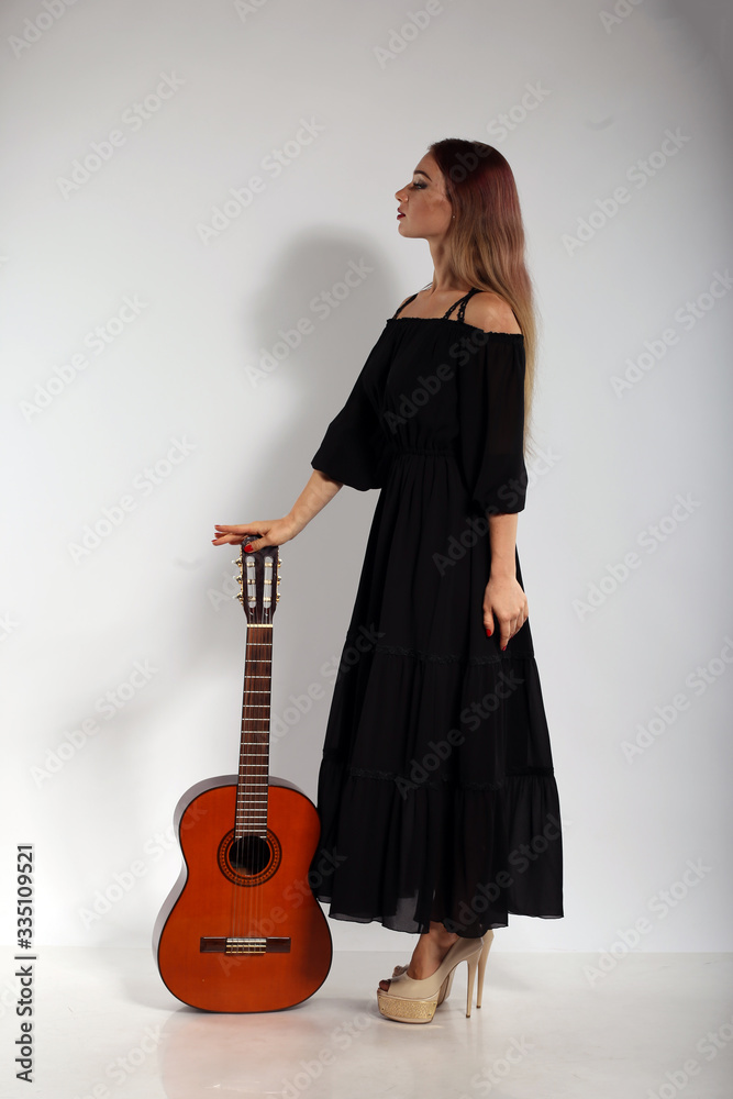 Pretty woman with a guitar on white background Pretty woman with a guitar on white background