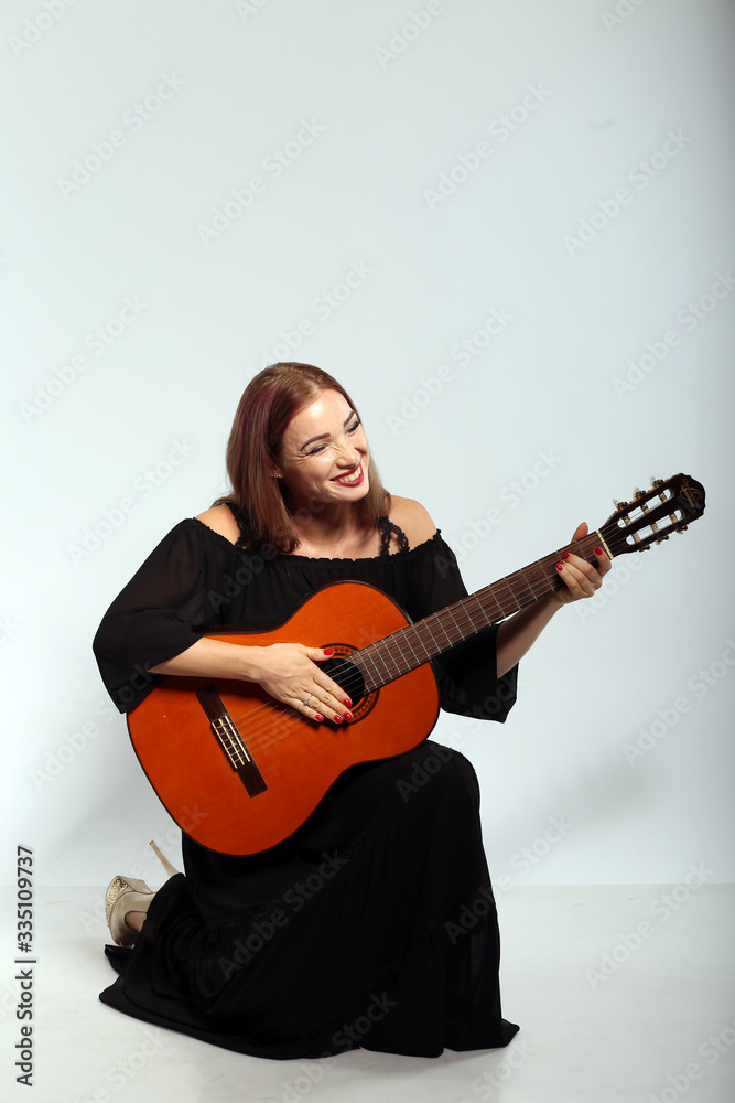 Pretty woman with a guitar on white background Pretty woman with a guitar on white background