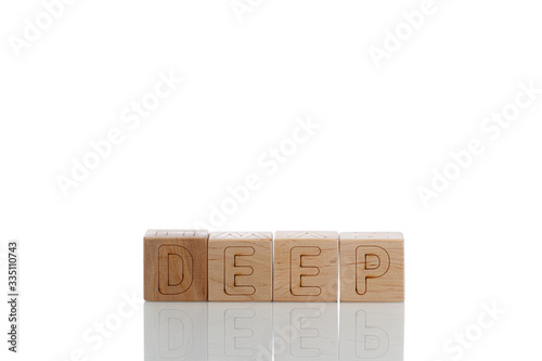 Wooden cubes with letters deep on a white background