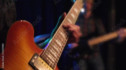 Close up of electric guitar during a rock concert in a small venue