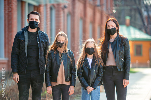 Family wearing masks to protect against Coronavirus and gripp