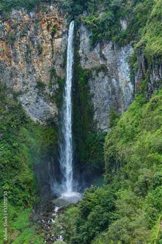 Sipiso Piso waterfall seen from above dropping from a huge rock cliff. Amazing place to relax or bath near Medan Toba