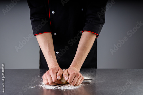 cooking dough sprinkling flour in a restaurant kitchen