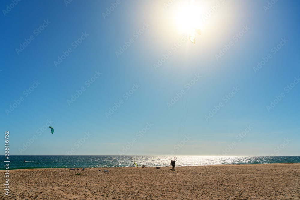 The athlete practices kate board surfing the sea on the waves. Summer in Portugal Algarve. The athlete practices kate board surfing the sea on the waves. Summer in Portugal Algarve.