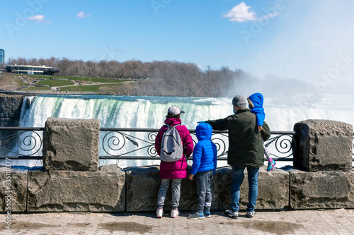 Social distancing guidelines for the COVID-19 coronavirus pandemic are in effect at Niagara Falls, Canada on April 1st, 2020, when the usually packed viewing platform held a single family.