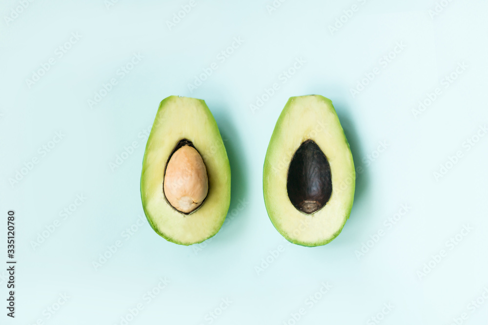 2 halves of avocado lie on a background top view