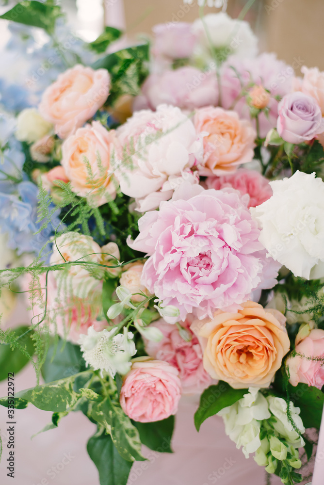 Wedding flowers, bridal decor closeup. Decoration made of peonies, roses and decorative plants
