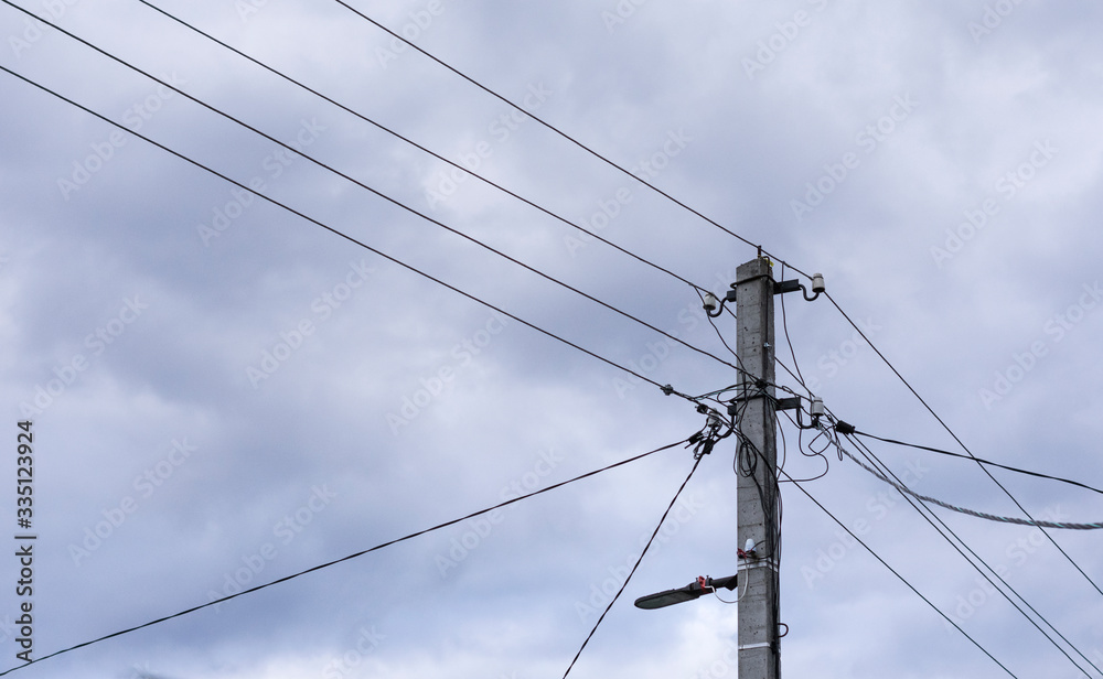 A power line pole with electrical wires isolated against the sky. Power line, power supply A power line pole with electrical wires isolated against the sky. Power line, power supply