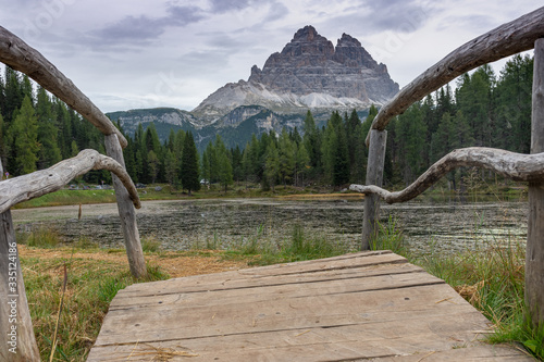 Italian Dolomites reflecting on the lake of Antorno on a cloudy autumn day