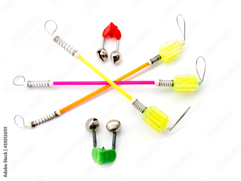 Bite alarm and fish bells isolated on white background. Composition of signaling devices for fishing. A set of tools for fishing. Bite alarm and fish bells isolated on white background. Composition of signaling devices for fishing. A set of tools for fishing.