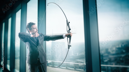 Business man points to success in business from his high-rise office