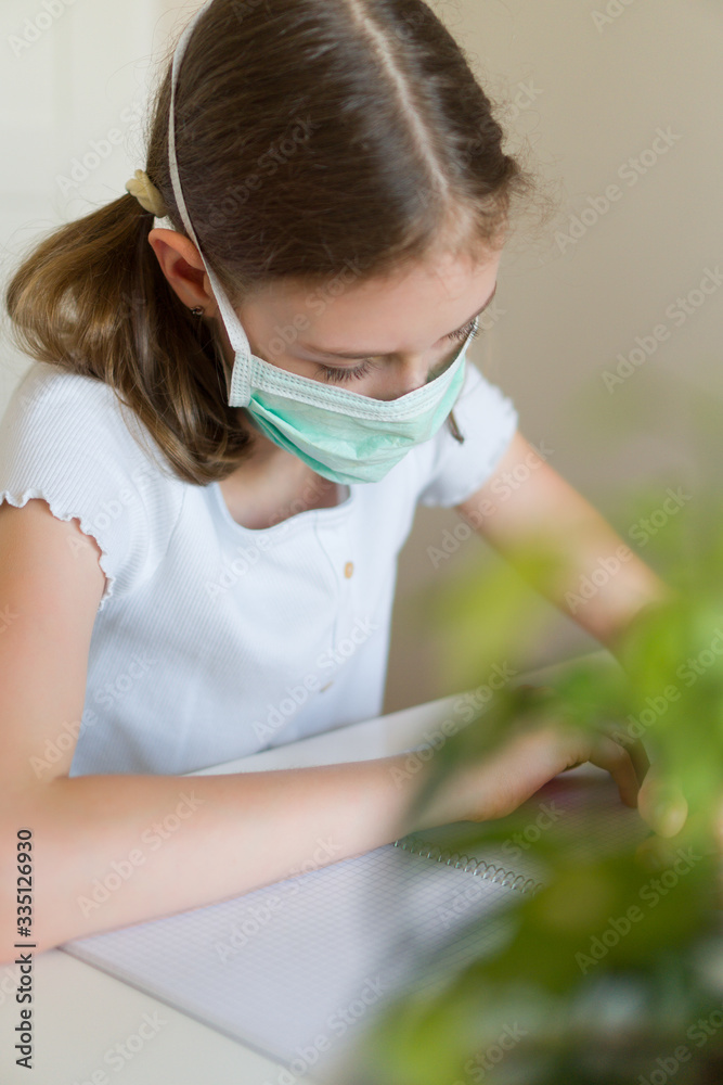 Little girl doing school homework during quarantine. Little girl doing school homework during quarantine.
