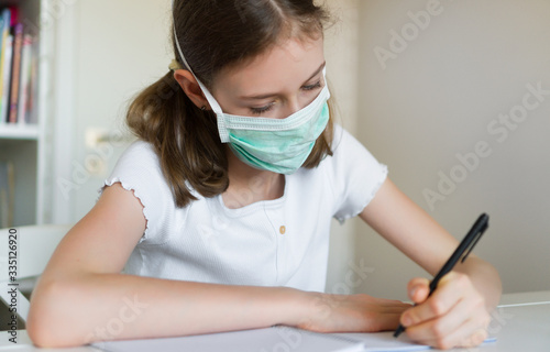 Little girl doing school homework during quarantine.