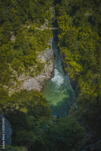 View of river Reka, flowing through UNESCO protected famous Skocjan Caves. Aerial view of the Skocjan caves with closeup of the river.