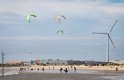 Kitesurfers enjoying a beautiful day at the beach