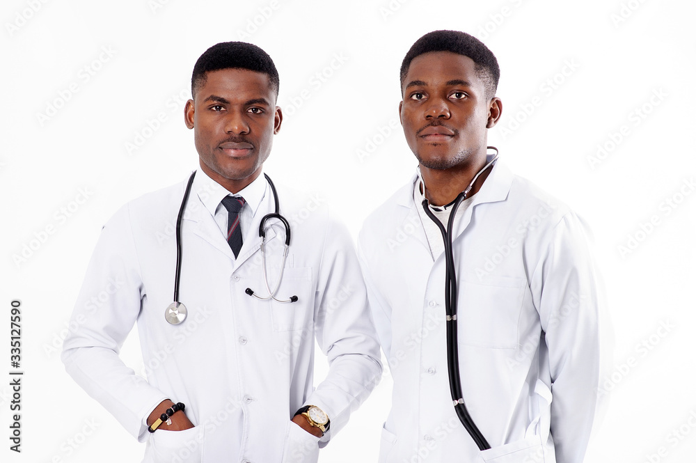 Two young african doctors on an isolated white background with a phonendoscope Two young african doctors on an isolated white background with a phonendoscope