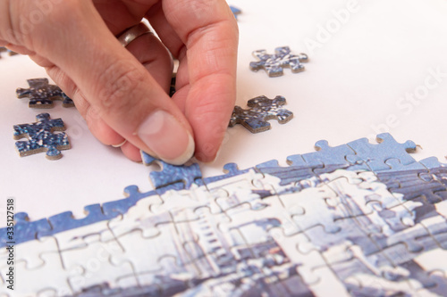woman hand putting puzzle pieces